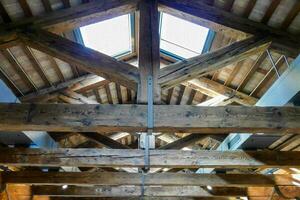 the interior of a building with wooden beams photo