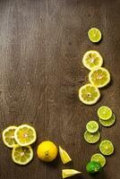 sliced lemon, lime on slate and wooden counter top background photo