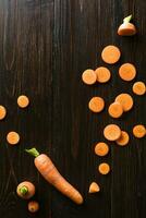 sliced carrot on slate and wooden counter top background photo