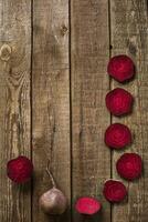 sliced beetroot on slate and wooden counter top background photo