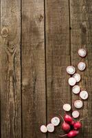 sliced radish on slate and wooden counter top background photo