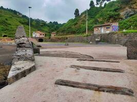 an empty beach with small buildings photo