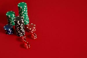 Poker chips on red background. Group of different poker chips. Casino background. photo