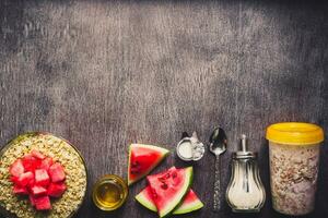 Ingredients for oatmeal on dark wooden table. Concept of healthy food. Top view, copy space. Toned photo