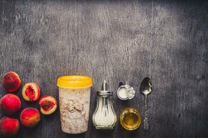 Ingredients for oatmeal on dark wooden table. Concept of healthy food. Top view, copy space. Toned photo