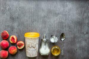 Ingredients for oatmeal on dark wooden table. Concept of healthy food. Top view, copy space. photo