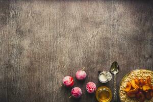 Healthy breakfast with oatmeal in a glass bowl and fruit on table. Toned photo