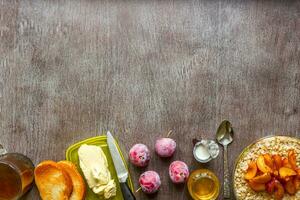 Oatmeal with plums, toast with butter and honey on a wooden table. The concept of a healthy breakfast photo