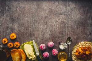 Healthy breakfast with oatmeal in a glass bowl and fruit on table. Toned photo