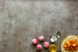 Healthy breakfast with oatmeal in a glass bowl and fruit on table photo