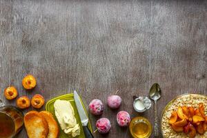 Oatmeal with plums, toast with butter and honey on a wooden table. The concept of a healthy breakfast photo