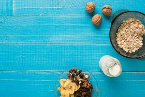 Porridge, oats, milk and banana on the table photo