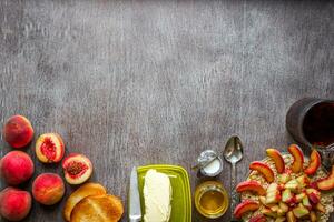 Oatmeal with peach, toast with butter and honey on a wooden table. The concept of a healthy breakfast photo