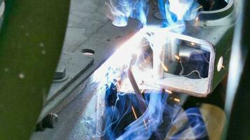 welding a metal piece with blue flames photo