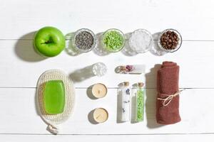 Composition of spa treatment on white wooden table with space for text. Top view photo