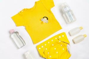 Baby clothes and accessories on white background. Top view photo