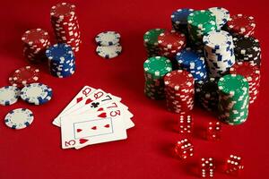 Casino gambling poker equipment and entertainment concept - close up of playing cards and chips at red background. Two pairs photo