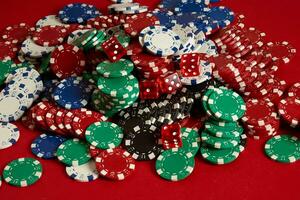 Stack of poker chips on red background at casino photo