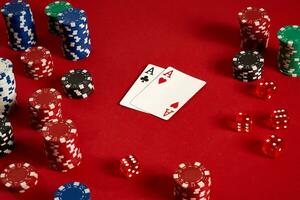 Poker cards and gambling chips on red background photo