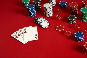 Poker cards and gambling chips on red background photo