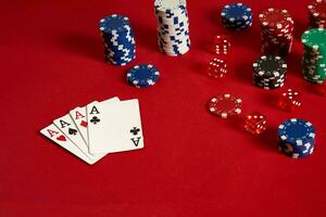 Poker cards and gambling chips on red background photo