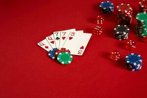 Poker cards and gambling chips on red background photo