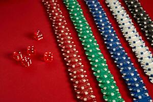 Stack of poker chips on red background at casino photo