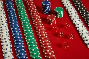 Stack of poker chips on red background at casino photo