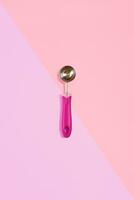 Ice cream scoop isolated on pink. Top view photo