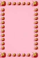 Colourful bright pattern with ripe strawberry. Top view. Pink background photo