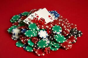 Poker cards and gambling chips on red background photo