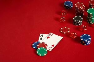 Poker cards and gambling chips on red background photo