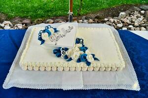 a white cake with blue decorations on top photo