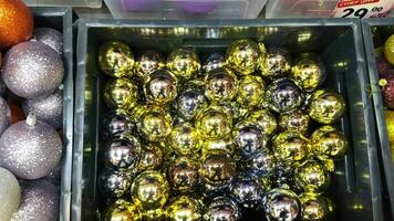 Boxes with spherical Christmas tree balls decorations in a shopping mall. Christmas decorations and Christmas balls for sale in the store, Christmas tree accessories. new year video