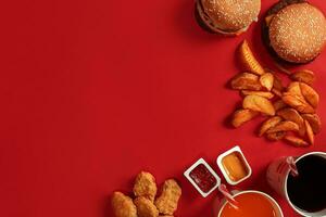 Burger and Chips. Hamburger and french fries in red paper box. Fast food on red background. photo