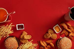 Burger and Chips. Hamburger and french fries in red paper box. Fast food on red background. photo