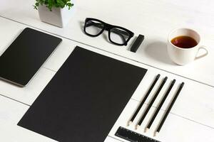 Modern workplace with digital tablet computer and mobile phone, cup of coffee, pen and empty sheet of paper. photo