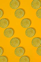 Lime pattern on yellow background. Minimal flat lay concept. photo