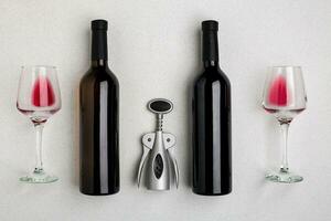 Red and white wine bottles and glasses, top view photo