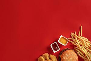 Burger and Chips. Hamburger and french fries in red paper box. Fast food on red background. photo