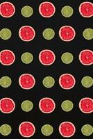 Grapefruit and lemon pattern isolated on black background. Flat lay photo