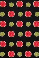 Grapefruit and lemon pattern isolated on black background. Flat lay photo