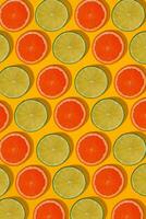 Grapefruit and lime pattern on yellow background. Minimal flat lay concept. photo