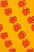 Grapefruit pattern on yellow background. Minimal flat lay concept. photo