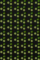 Lime pattern on black background. Minimal flat lay concept. photo