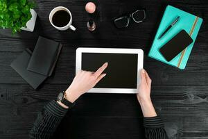 Mix of office supplies and gadgets on a wooden desk background. View from above. photo