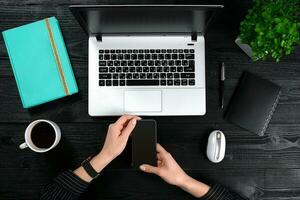 Overhead view of businesswoman working at computer in office photo