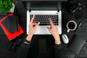 Overhead view of businesswoman working at computer in office photo