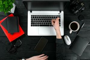 Overhead view of businesswoman working at computer in office photo