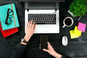 Overhead view of businesswoman working at computer in office photo